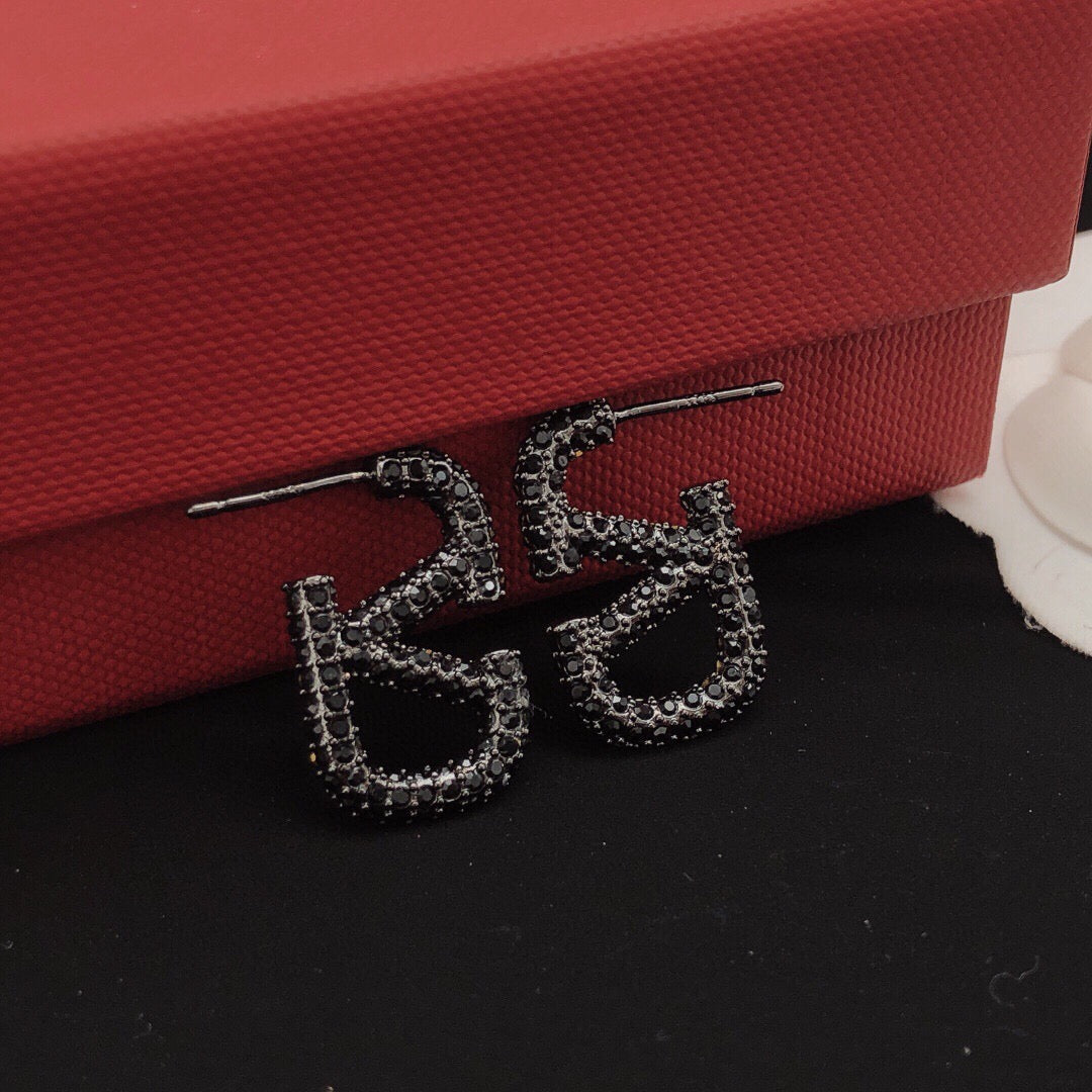 Martin Graham stud earrings in polished metal-tone – detail view